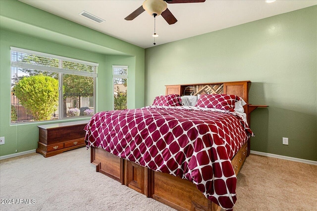 bedroom featuring light carpet and ceiling fan