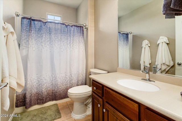 bathroom featuring tile patterned flooring, vanity, and toilet