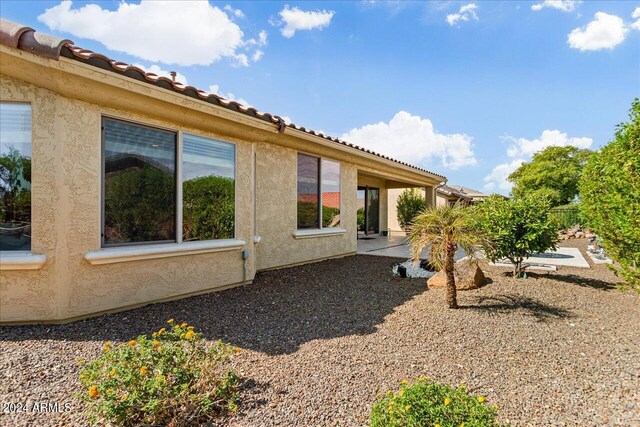 view of side of home with a patio area