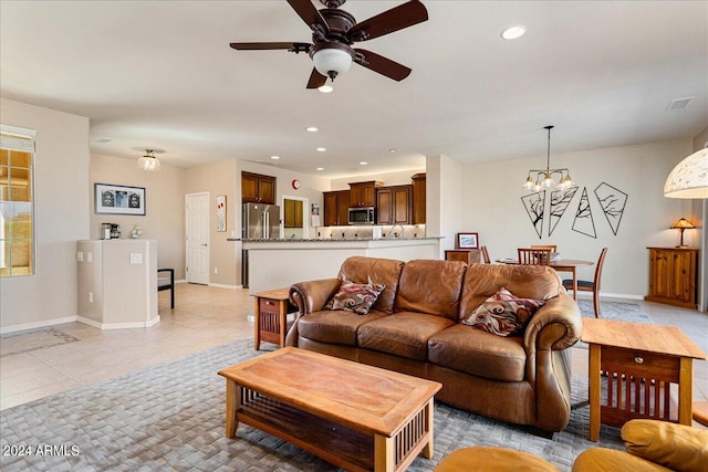 living room with ceiling fan with notable chandelier and light tile patterned flooring