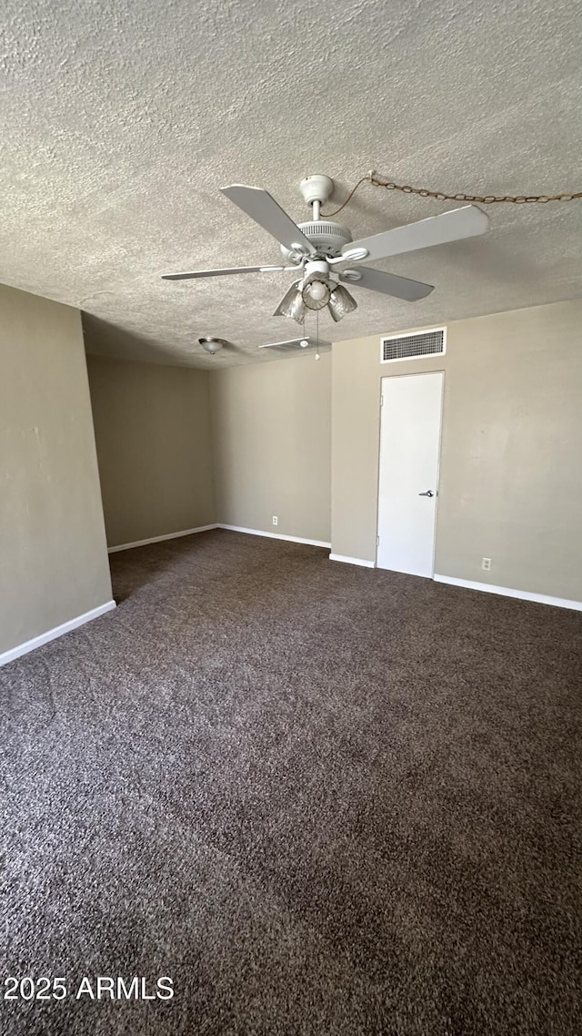 empty room with ceiling fan, carpet, and a textured ceiling