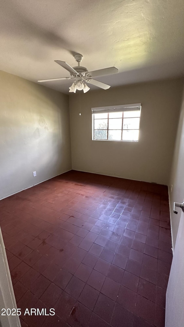 unfurnished room with ceiling fan