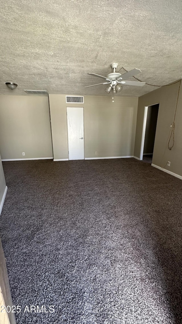 carpeted empty room featuring a textured ceiling and ceiling fan