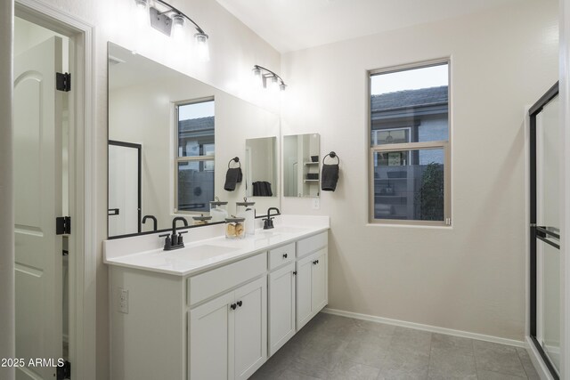 19022 W Rose Ln, Waddell, AZ 85355 - bathroom featuring baseboards, double vanity, and a sink