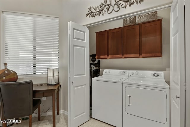 laundry area featuring cabinets and washing machine and dryer