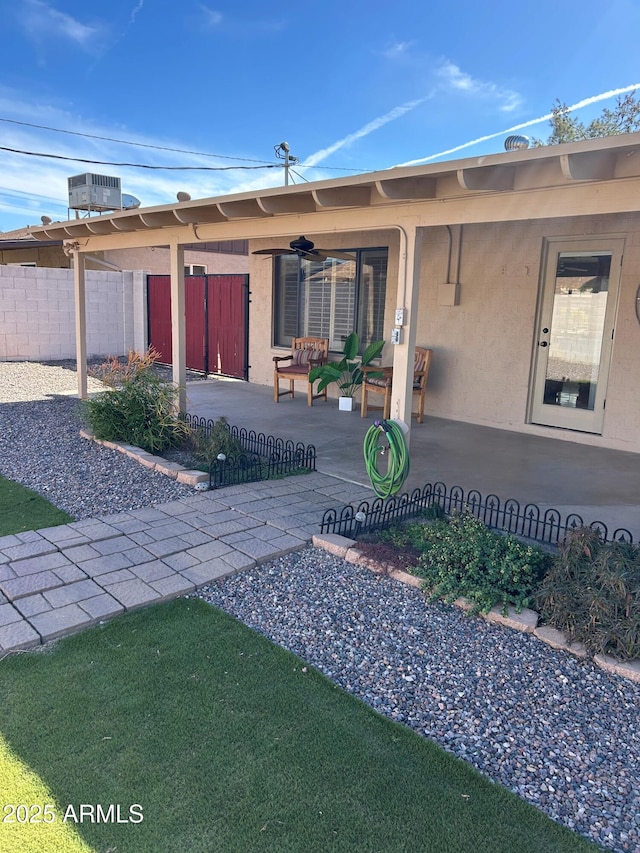 8538 E Vista Dr, Scottsdale, AZ 85250 - doorway to property with ceiling fan, stucco siding, and a patio