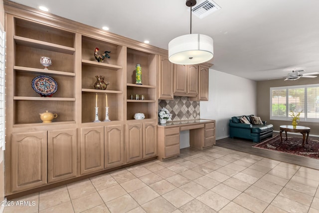8538 E Vista Dr, Scottsdale, AZ 85250 - kitchen with built in desk, light tile patterned floors, backsplash, open floor plan, and a ceiling fan