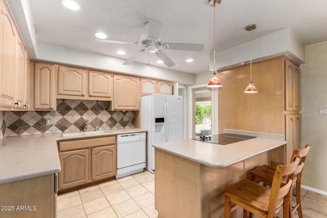 8538 E Vista Dr, Scottsdale, AZ 85250 - kitchen with white appliances, a peninsula, a ceiling fan, tasteful backsplash, and light tile patterned flooring