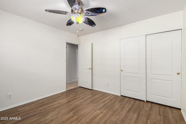 8538 E Vista Dr, Scottsdale, AZ 85250 - unfurnished bedroom featuring wood finished floors, a closet, and a ceiling fan