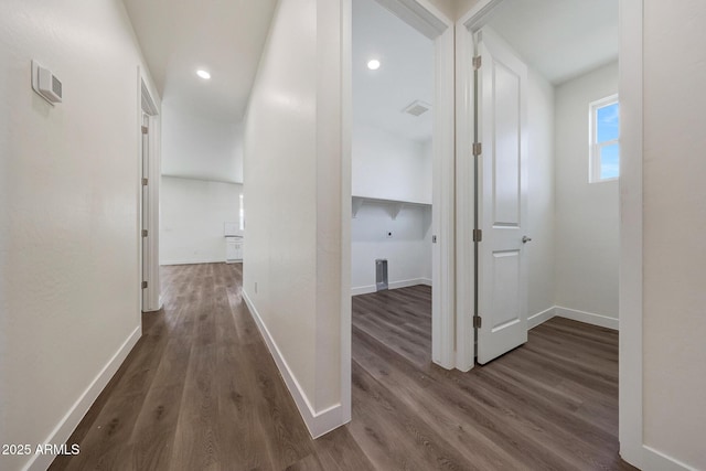 corridor featuring recessed lighting, dark wood finished floors, visible vents, and baseboards