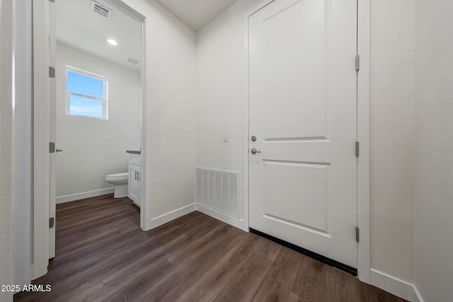 bathroom with visible vents, vanity, toilet, and wood finished floors