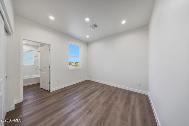 unfurnished bedroom with recessed lighting, visible vents, dark wood finished floors, and baseboards