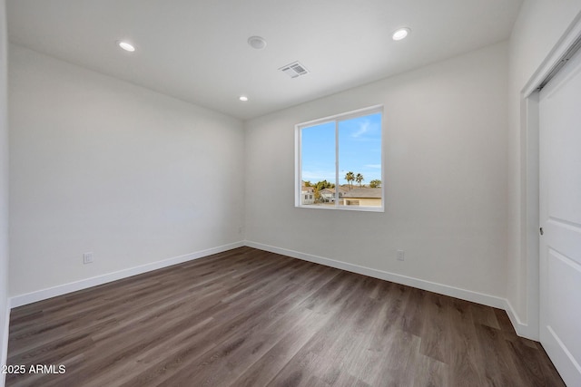 unfurnished bedroom with dark wood-style floors, recessed lighting, visible vents, and baseboards