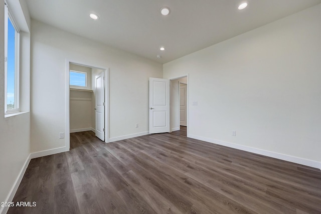 unfurnished bedroom featuring baseboards, dark wood-type flooring, and recessed lighting