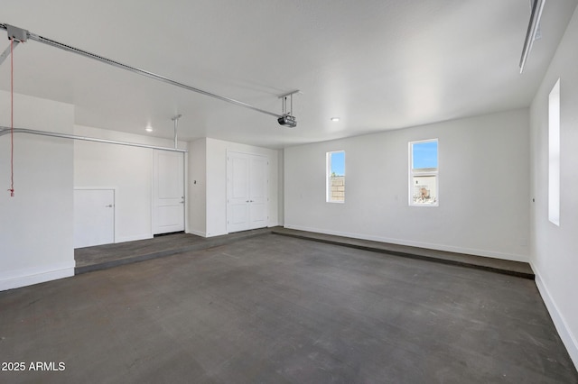 garage with a garage door opener and baseboards