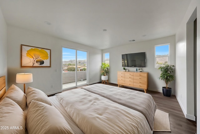 bedroom with baseboards, access to outside, visible vents, and dark wood-type flooring