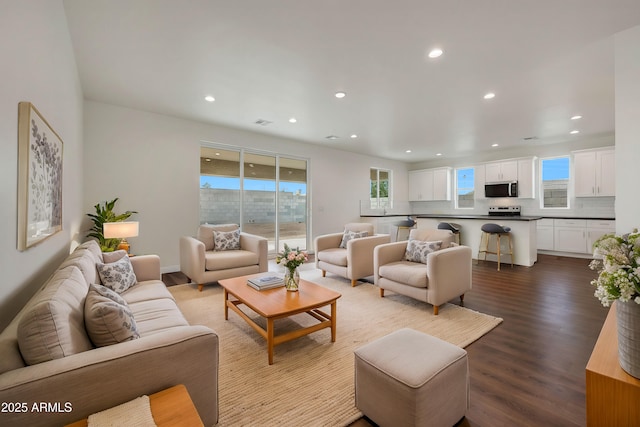 living area with a wealth of natural light, visible vents, light wood finished floors, and recessed lighting