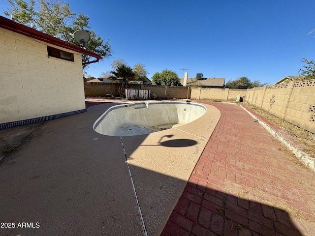 view of pool with a patio area, a fenced in pool, and a fenced backyard