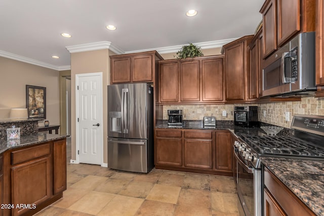 kitchen featuring decorative backsplash, crown molding, dark stone counters, and appliances with stainless steel finishes