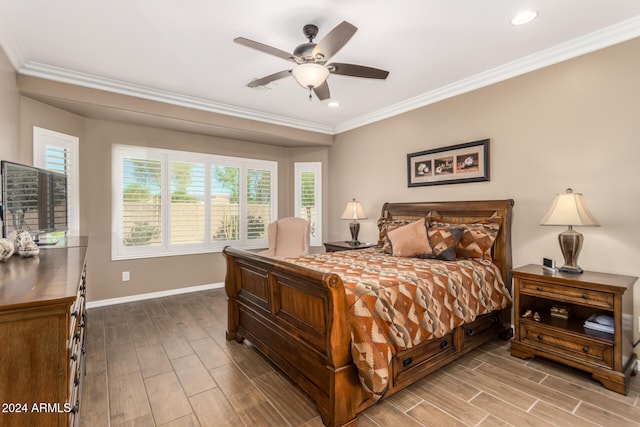 bedroom with ceiling fan, light hardwood / wood-style floors, ornamental molding, and multiple windows