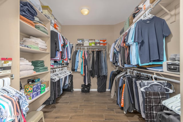 spacious closet featuring dark hardwood / wood-style flooring