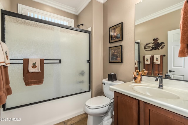 full bathroom featuring vanity, tile patterned floors, crown molding, toilet, and enclosed tub / shower combo