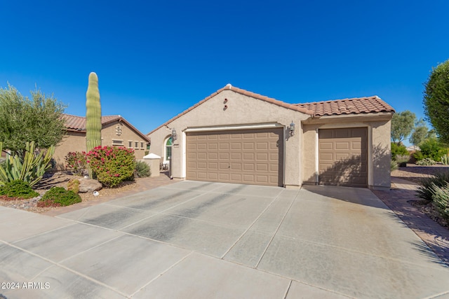 mediterranean / spanish-style home with a garage