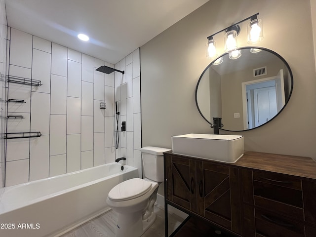 full bathroom with visible vents, shower / bathing tub combination, toilet, and vanity