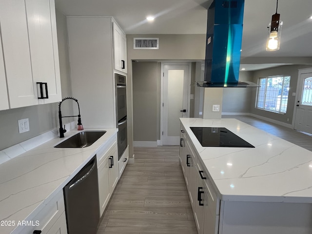 kitchen featuring island range hood, visible vents, black electric cooktop, a sink, and dishwashing machine
