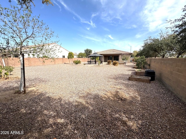 view of yard with a gazebo and a fenced backyard