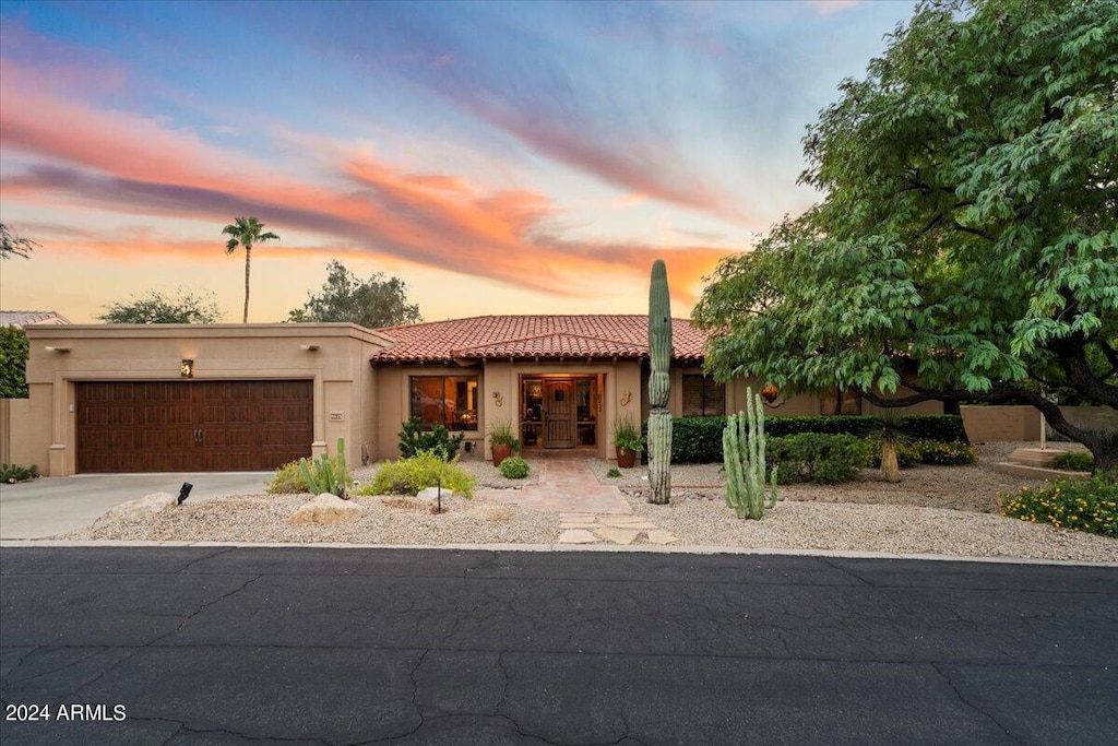 southwest-style home with a garage