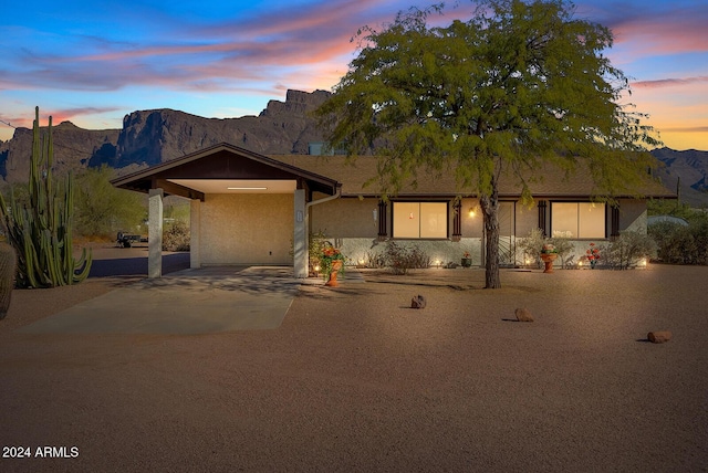 view of front of house with a mountain view and a carport