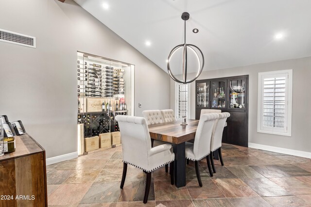 10658 E Cinnabar Ave, Scottsdale, AZ 85258 - dining room with lofted ceiling, baseboards, visible vents, and stone tile flooring