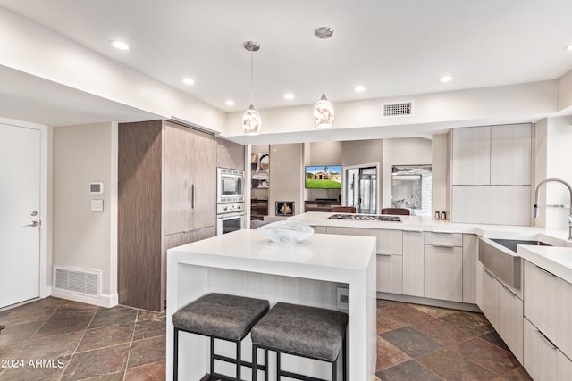 10658 E Cinnabar Ave, Scottsdale, AZ 85258 - kitchen with stone tile flooring, modern cabinets, visible vents, a sink, and stainless steel appliances