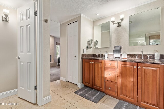 10658 E Cinnabar Ave, Scottsdale, AZ 85258 - bathroom featuring a sink, crown molding, double vanity, and tile patterned flooring
