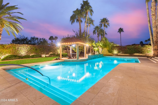 10658 E Cinnabar Ave, Scottsdale, AZ 85258 - pool at dusk with a gazebo, a patio area, and an outdoor pool