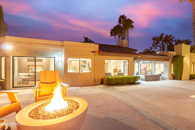 10658 E Cinnabar Ave, Scottsdale, AZ 85258 - back of property with a chimney, a patio, stucco siding, a tile roof, and a fire pit