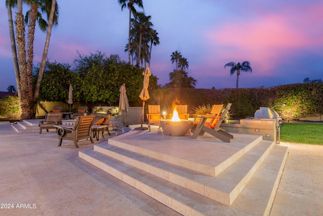 10658 E Cinnabar Ave, Scottsdale, AZ 85258 - patio terrace at dusk featuring a fire pit