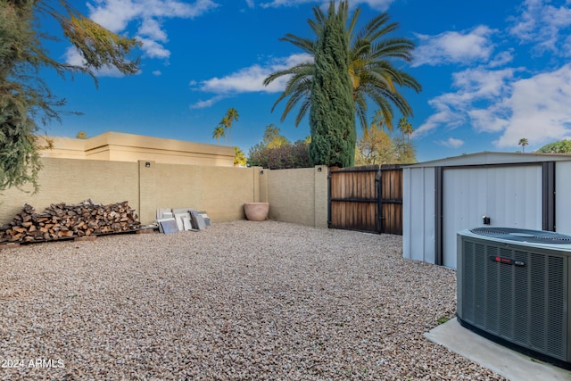 10658 E Cinnabar Ave, Scottsdale, AZ 85258 - view of yard featuring a storage shed, a gate, fence, central air condition unit, and an outdoor structure