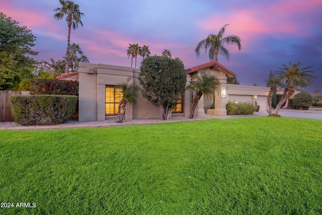 10658 E Cinnabar Ave, Scottsdale, AZ 85258 - view of front facade featuring fence, concrete driveway, a garage, stucco siding, and a front yard