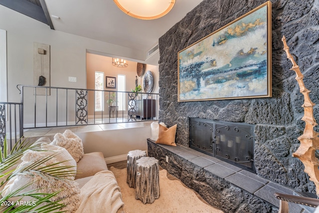 living room with a high end fireplace and a chandelier