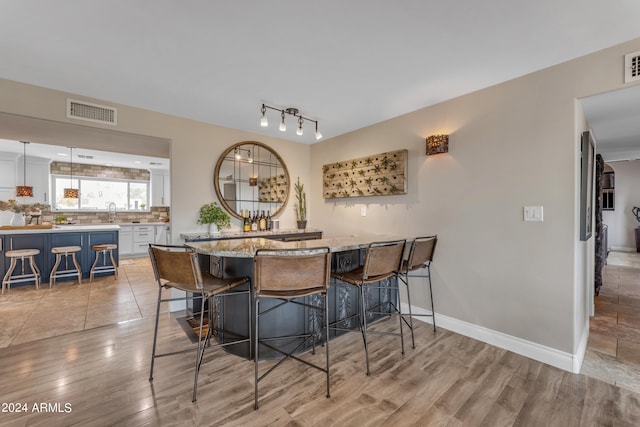 dining space featuring light hardwood / wood-style flooring and sink