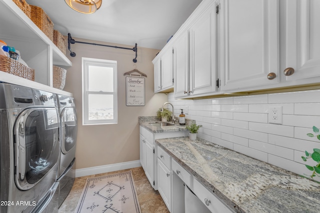 laundry area featuring cabinets, light tile patterned flooring, independent washer and dryer, and sink