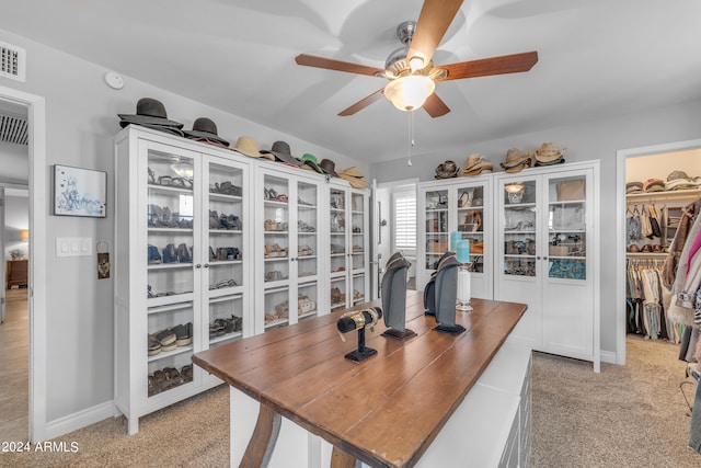 carpeted office with ceiling fan