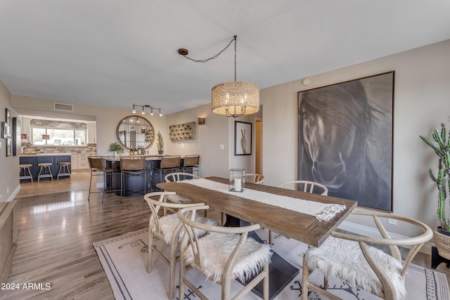 dining room with a chandelier and wood-type flooring