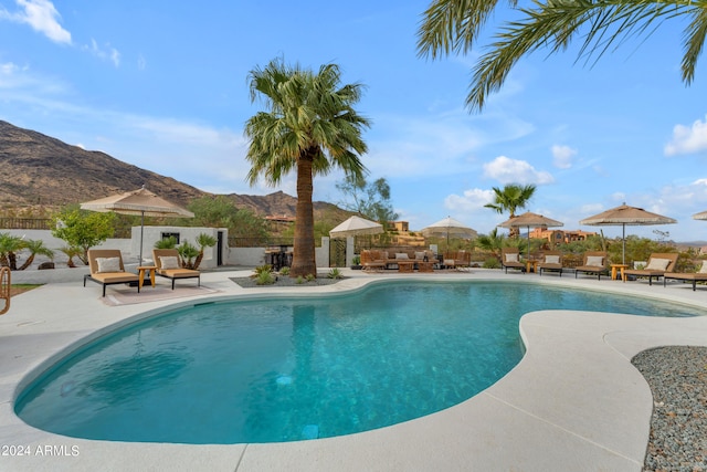 view of pool featuring a patio area and a mountain view