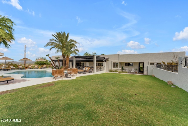 rear view of house featuring a yard and a patio