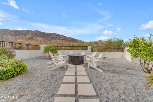 view of patio featuring a mountain view and an outdoor fire pit