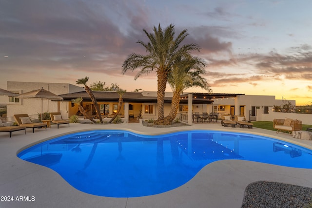 pool at dusk with a patio