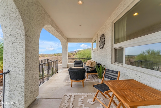 view of patio with outdoor lounge area and a balcony